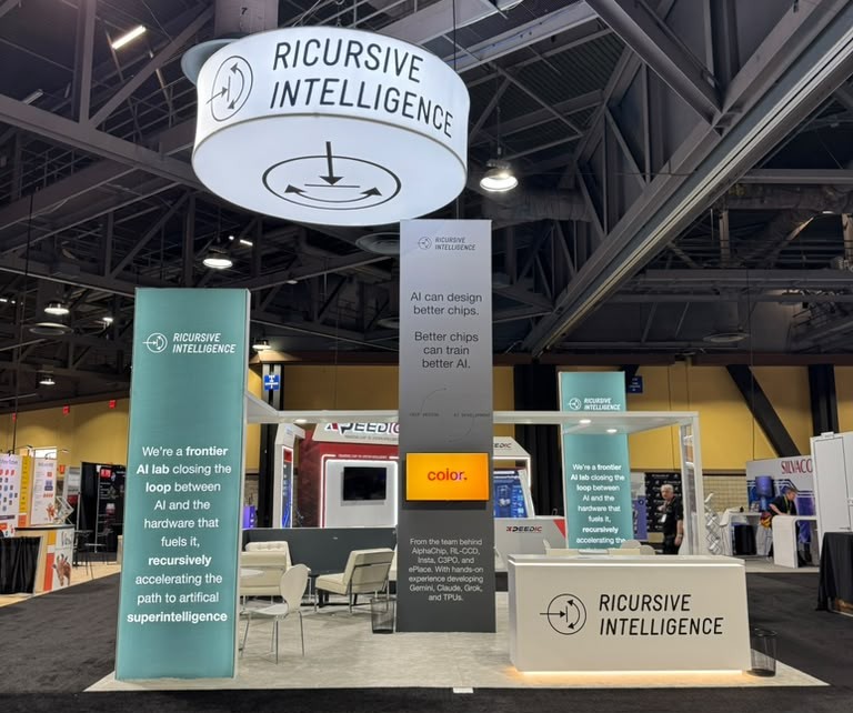 Custom architectural exhibit tower for Ricursive Intelligence at DAC 2026, showcasing modular aluminum frame construction and branded graphics.