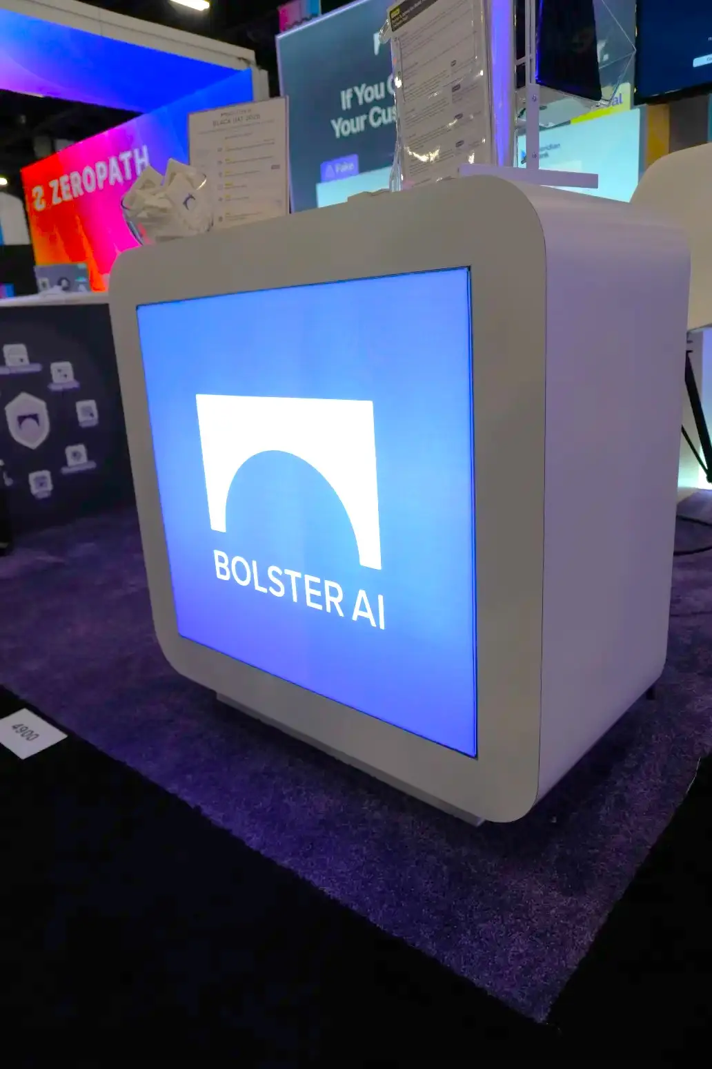 Custom trade show booth with large illuminated counter display featuring AI company branding and modern design elements, installed by Elevate Exhibits