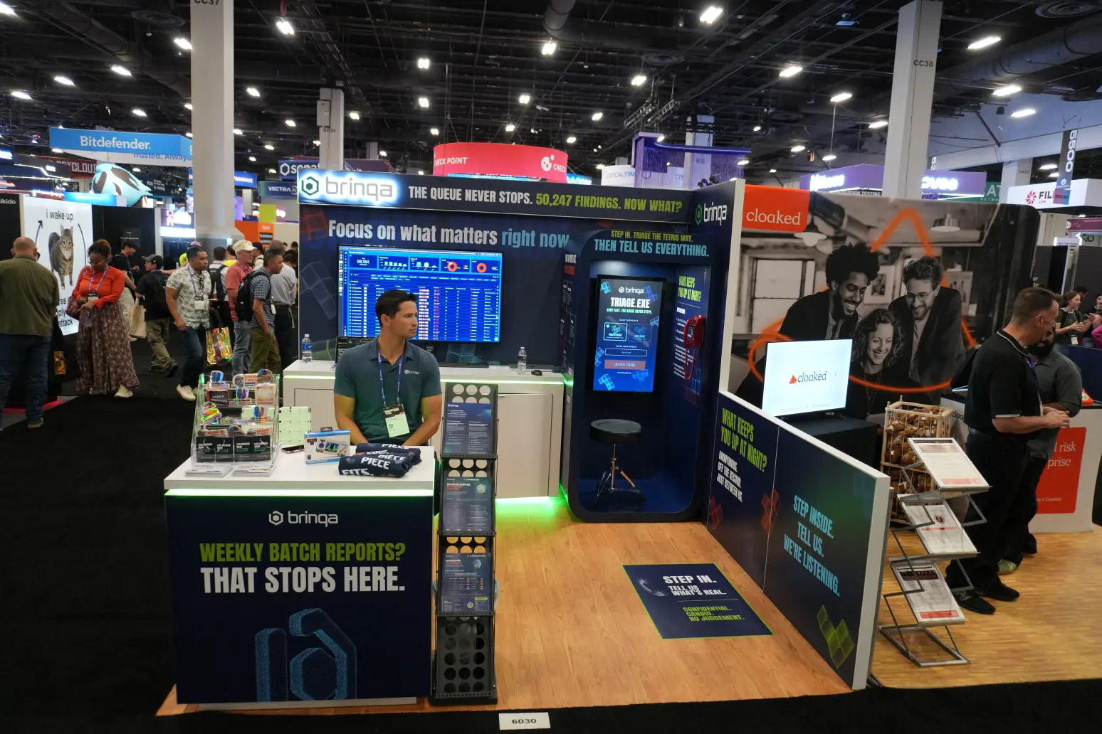 Custom trade show booth design for Brinqa at cybersecurity conference, featuring custom designed and built exhibit elements with LED backlit display.