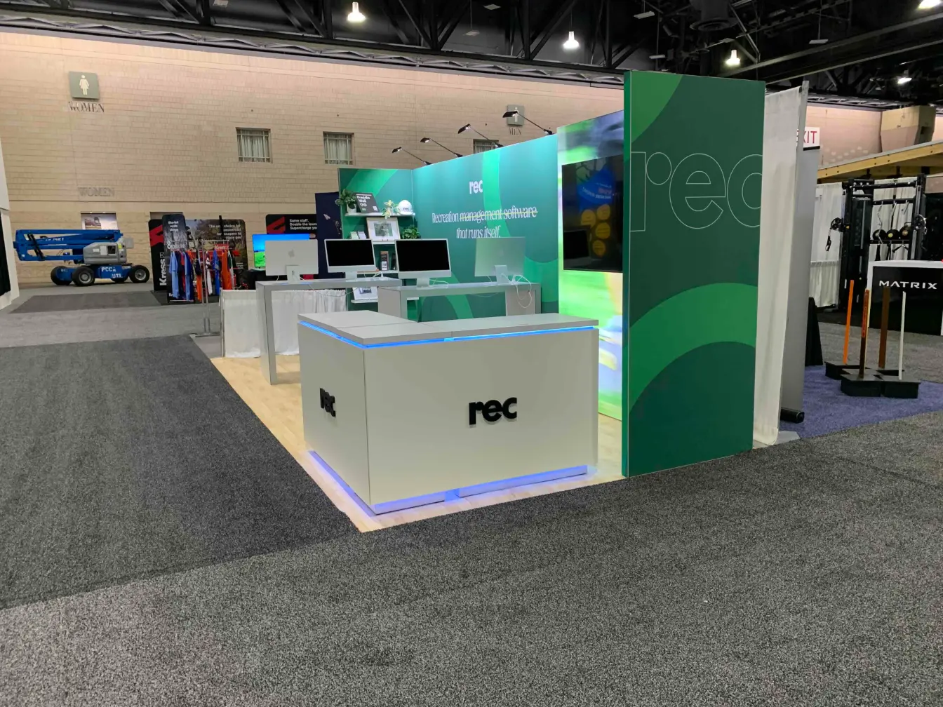 REC Technologies 10x20 trade show booth with illuminated reception desk and software demo stations at NRPA