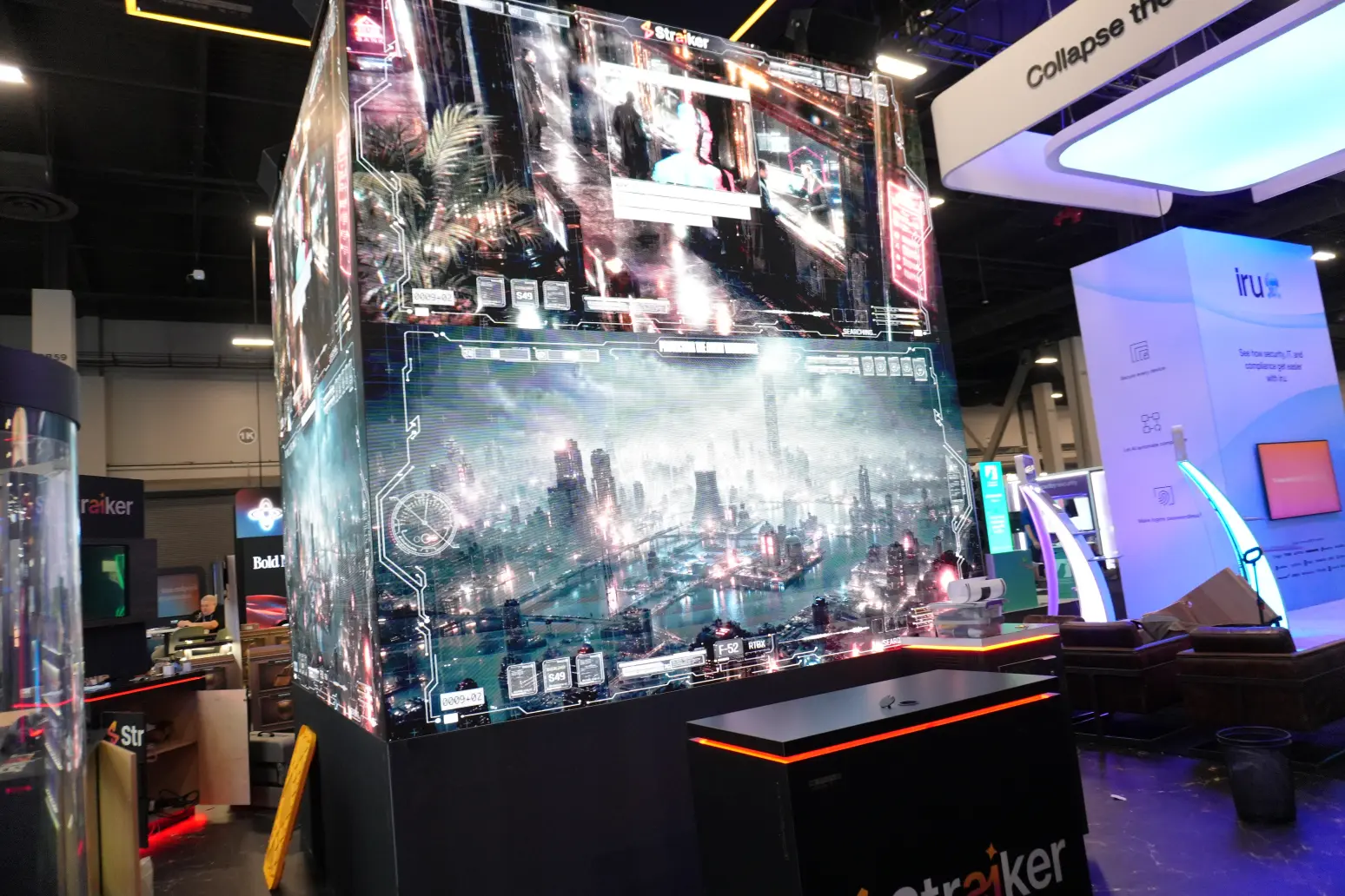 Straiker AI interactive LED cube booth with immersive digital displays and branded backlit wall signage at tech trade show.