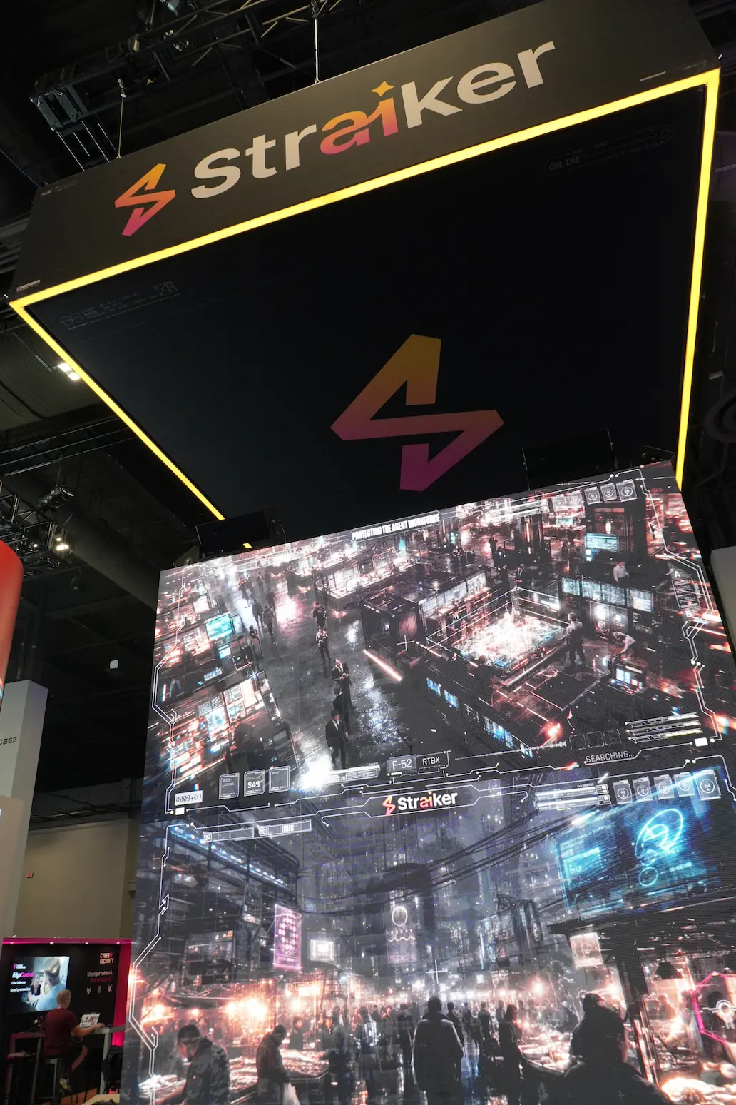 Straiker AI custom trade show booth featuring illuminated LED video tower display and overhead hanging sign, built by Elevate Exhibits.