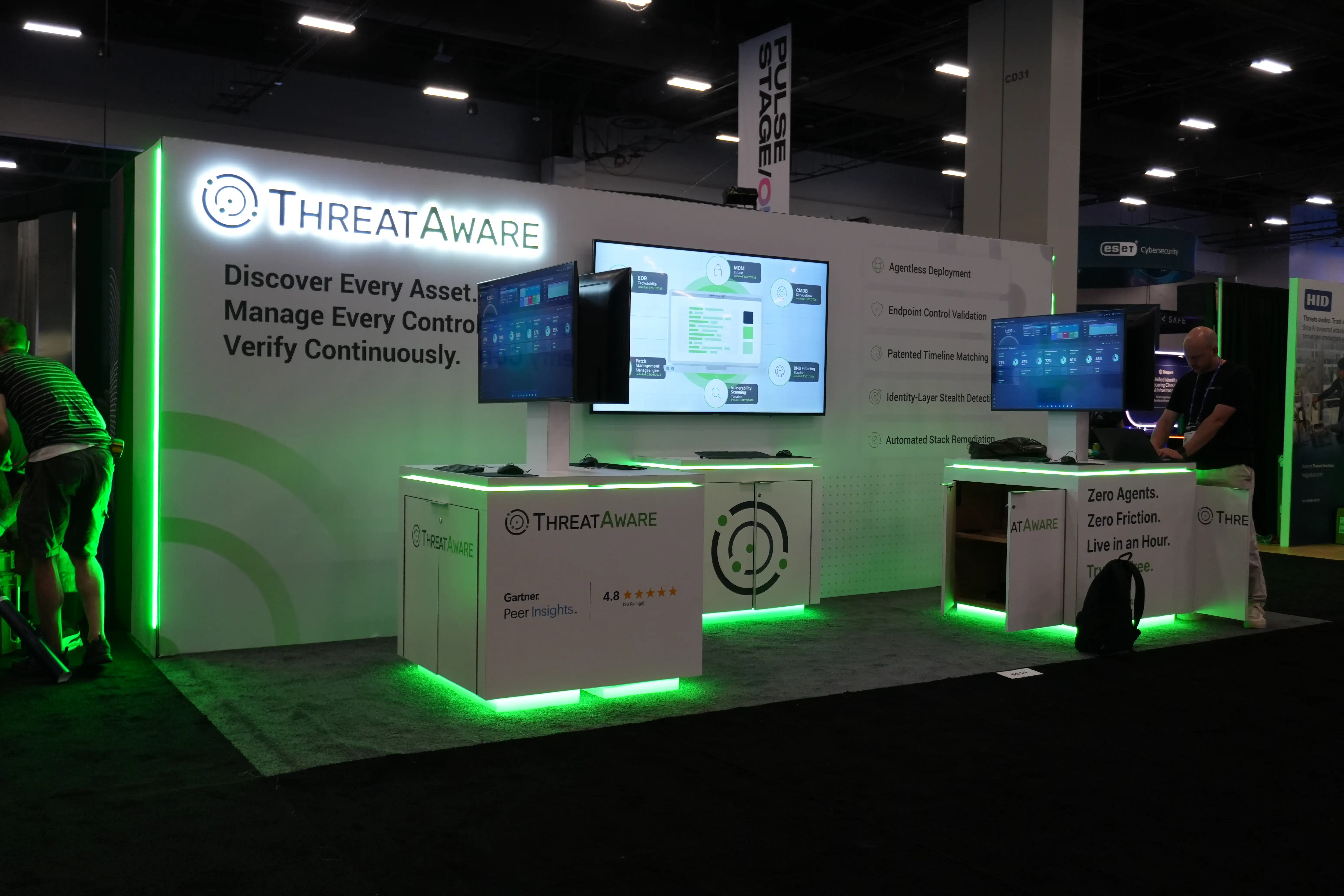 Trade show booth design by Elevate Exhibits featuring interactive displays for MRI scanning technology, showcasing Pioneer, Empower, and Discover with branding elements and modern aesthetics.